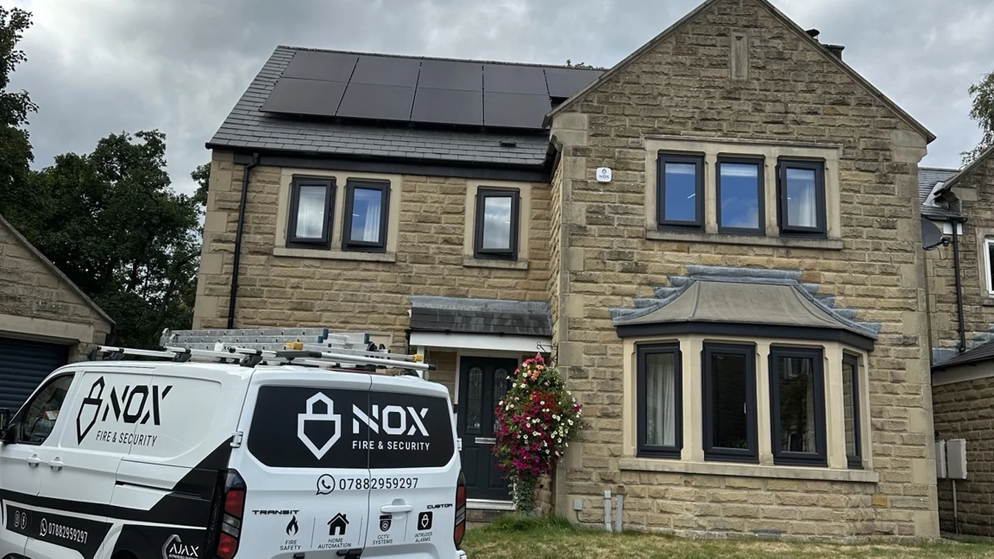 NOX Fire & Security van outside a stone-built detached home in Bakewell