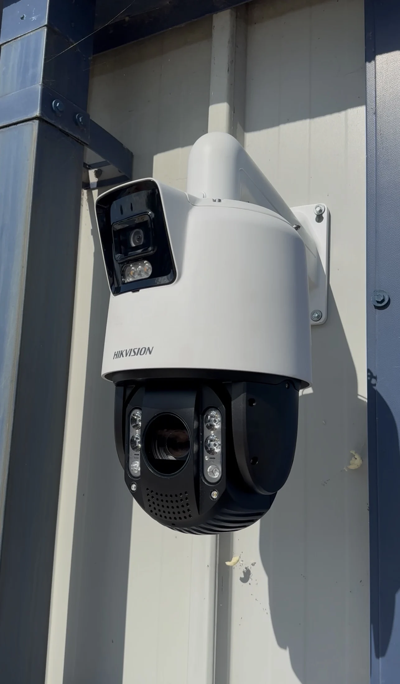Hikvision dual-lens PTZ CCTV camera installed on industrial cladding