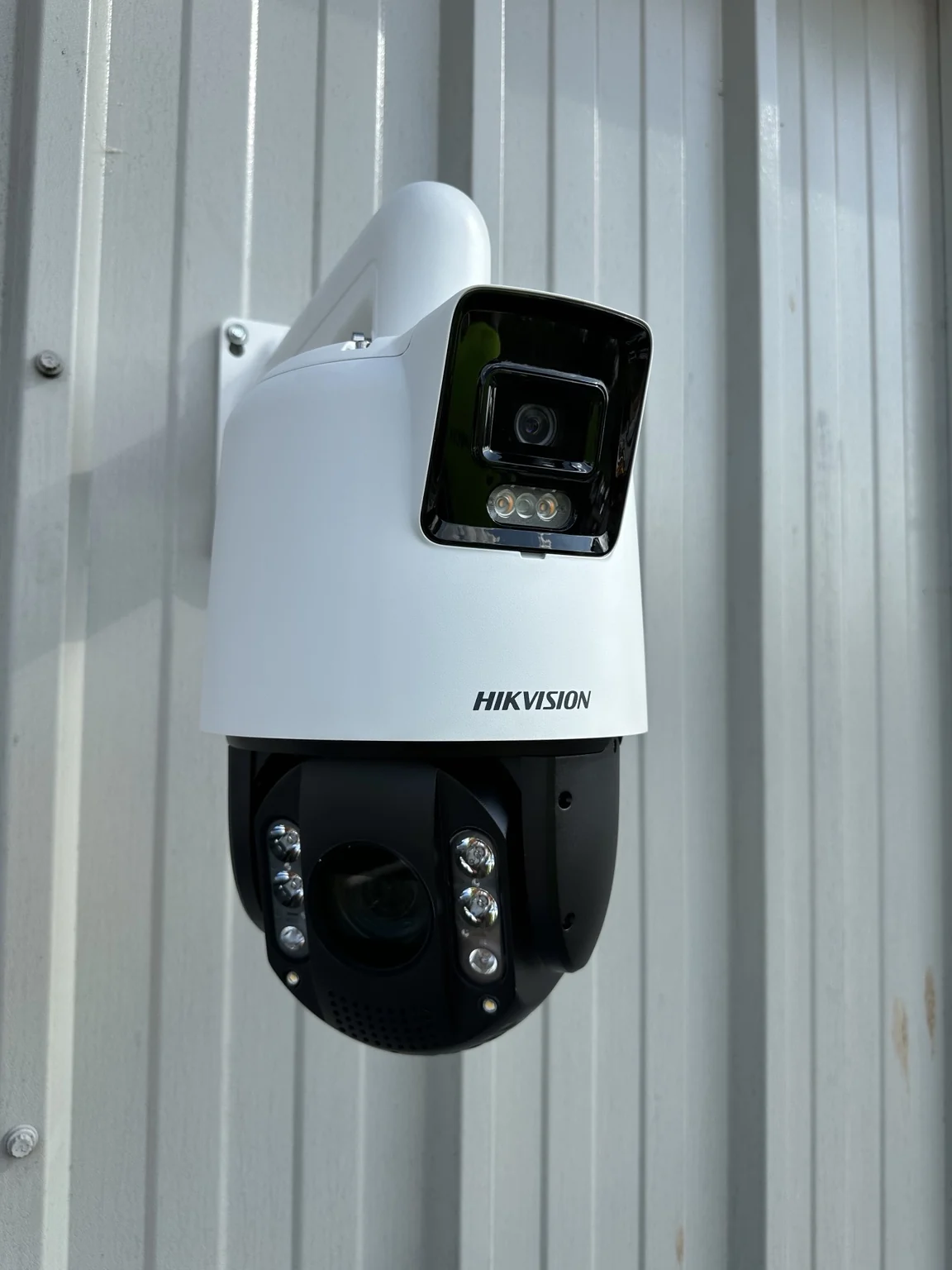 Angled view of Hikvision dual-lens PTZ camera and wall bracket