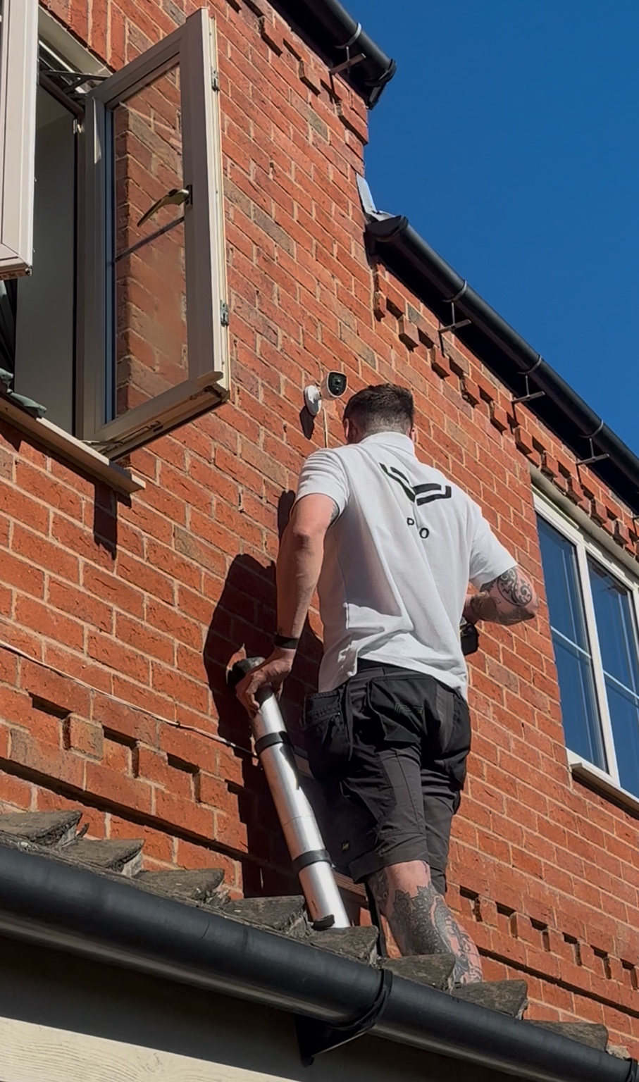 NOX engineer installing residential CCTV on brickwork